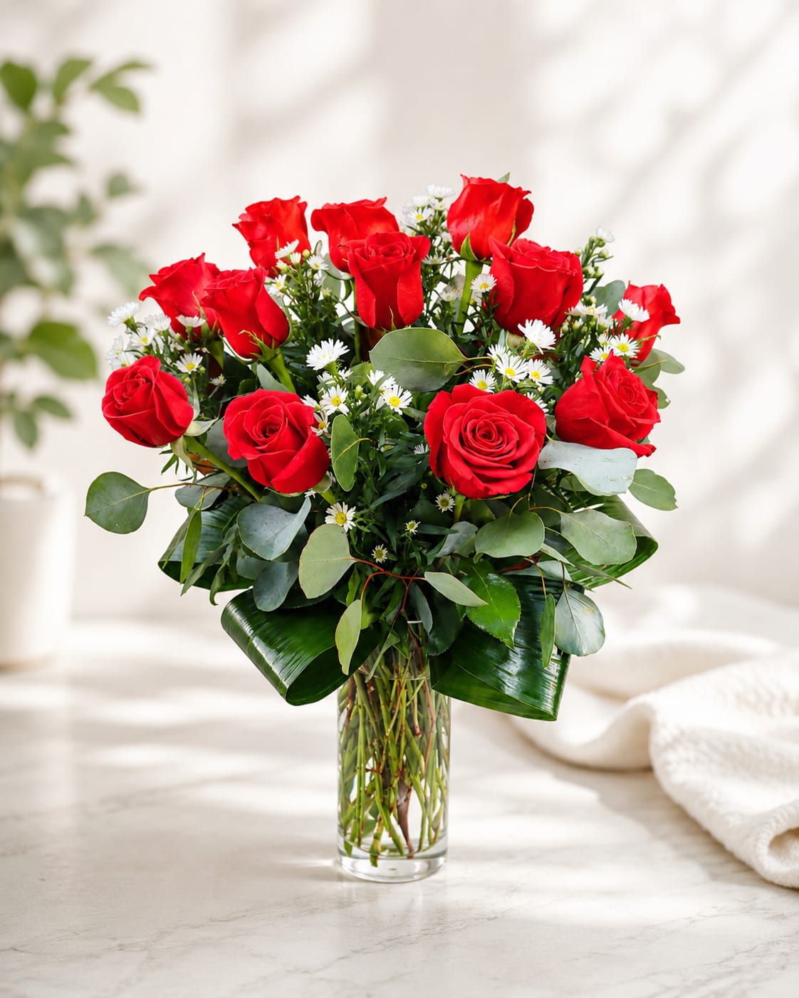 Forever Yours Roses - A timeless arrangement of fresh red roses accented with delicate white filler flowers and lush greenery, beautifully designed in a clear glass vase. Perfect for Valentine’s Day, anniversaries, or expressing love and appreciation any day of the year.