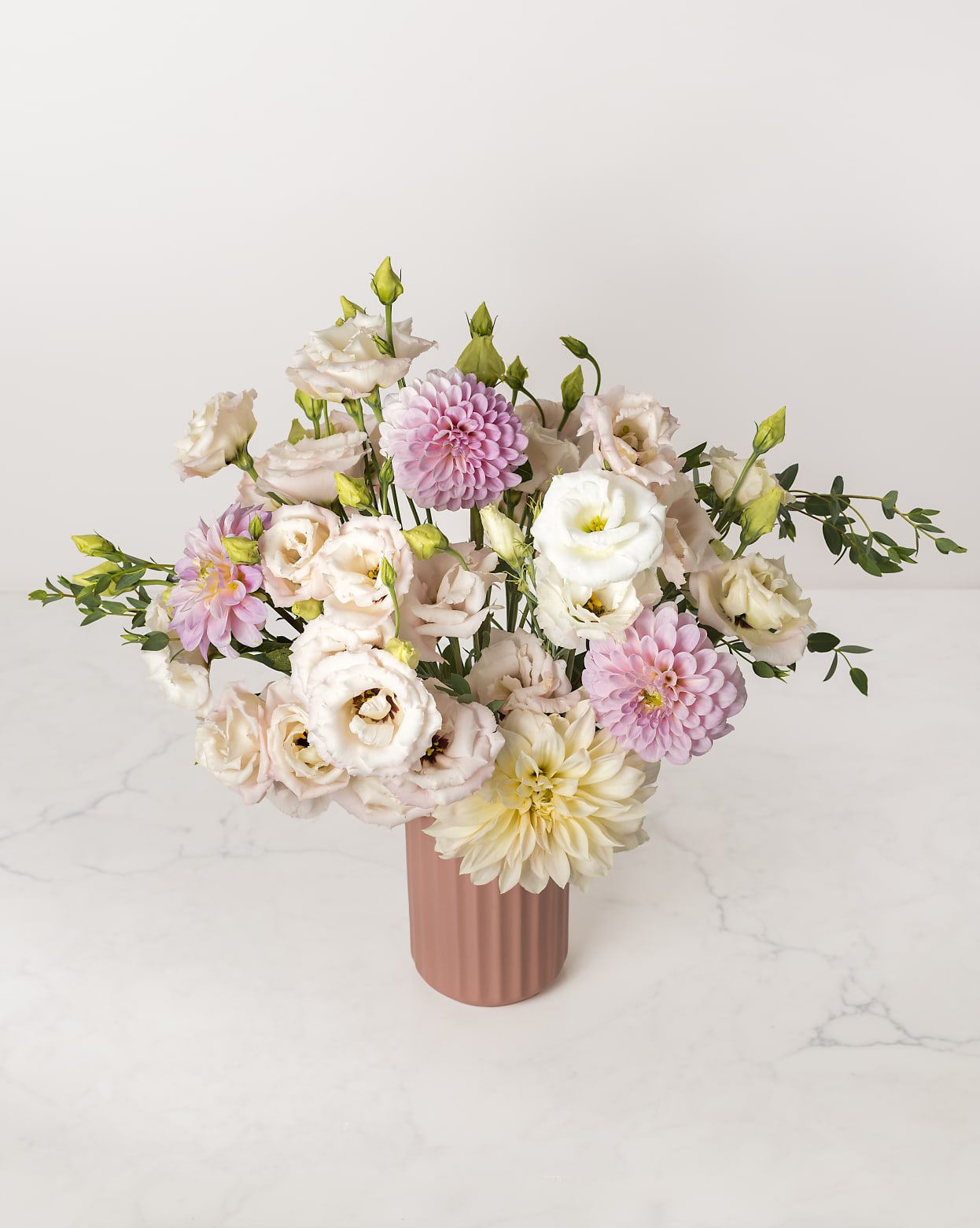 Pretty in Pink - Bright, beautiful, and blushing -- this arrangement of soft pinks could steal anyone's heart!  Multitudes of swoon-worthy local lisianthus and dahlias fill a raspberry sherbet-toned ceramic vase, accented by delicate touches of local eucalyptus foliage.  Standard arrangement measures approximately 18" x 18". 
