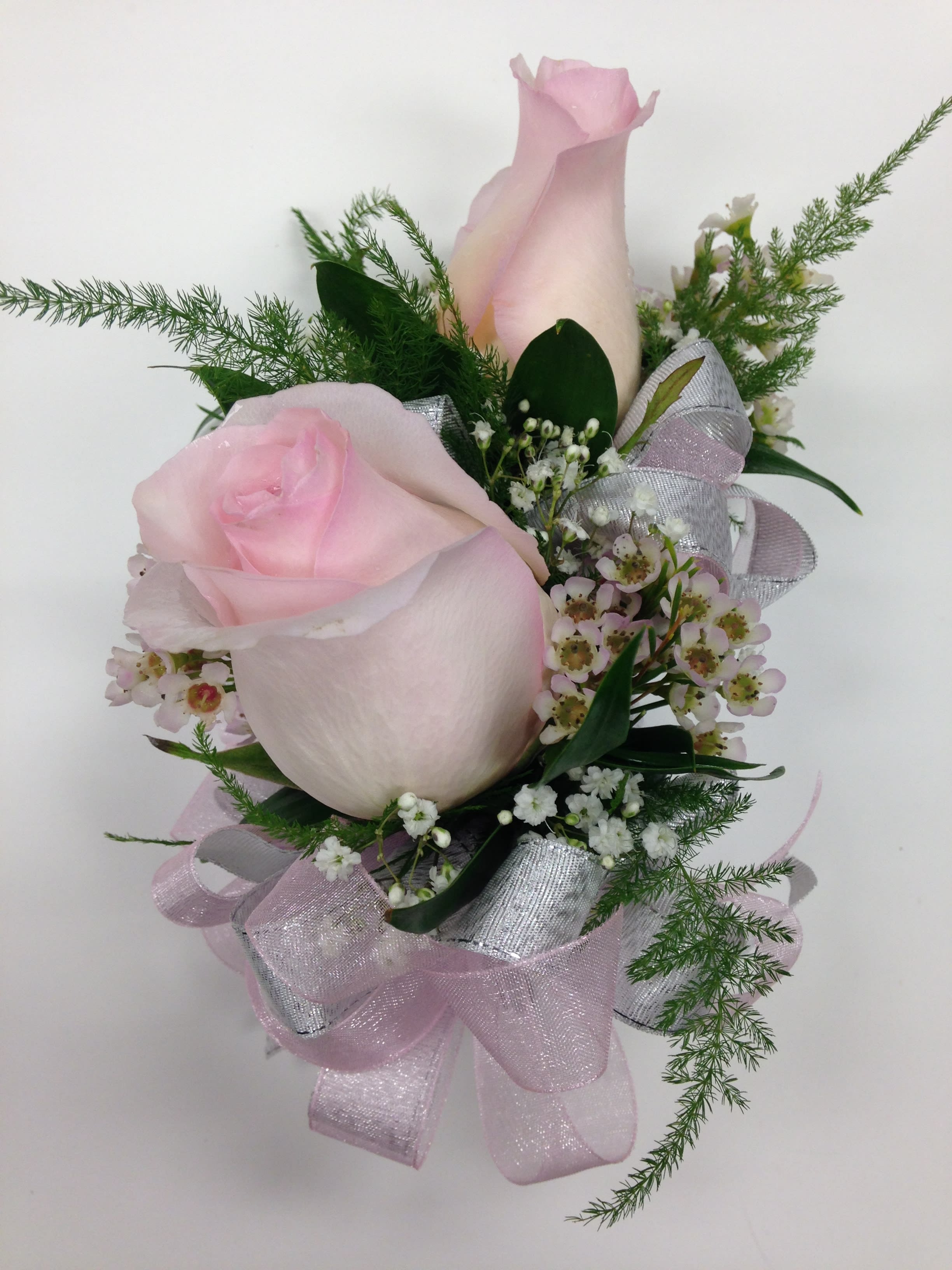 Two Rose Corsage - Colors and ribbons may vary. If ordering please specify color of dress, color of roses preferred and color of ribbon preferred. Please include 2nd choice for rose colors. If Rose color and/or Ribbon color is unavailable we will call you by phone with options. 