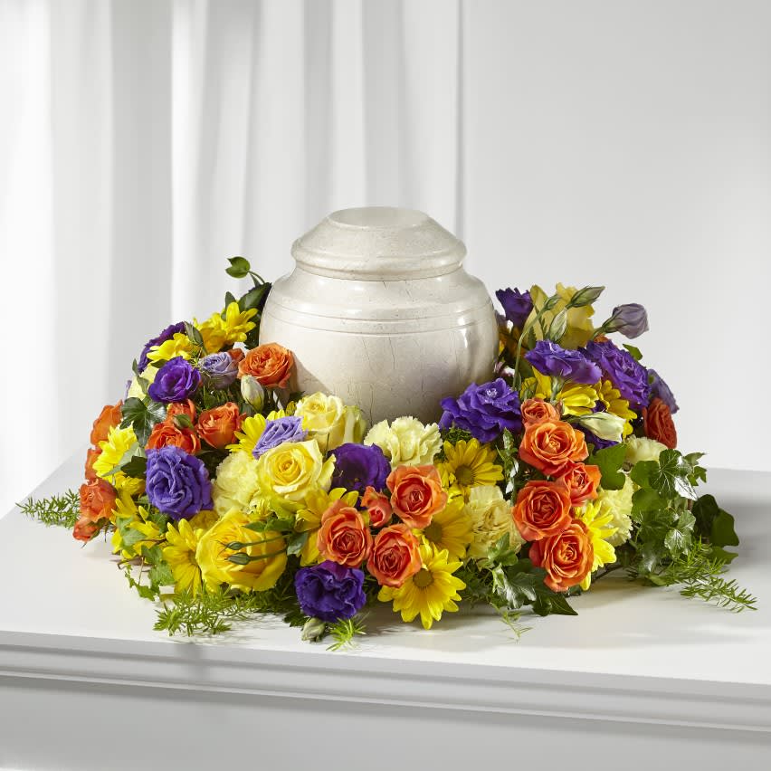 Blossoms of Remembrance Cremation Adornment - Memorialize your loved one by including an urn or photo tribute with our Blossoms of Remembrance Cremation Adornment. This thoughtful tabletop ring of flowers is handcrafted by a local florist with lisianthus, roses and carnations. 