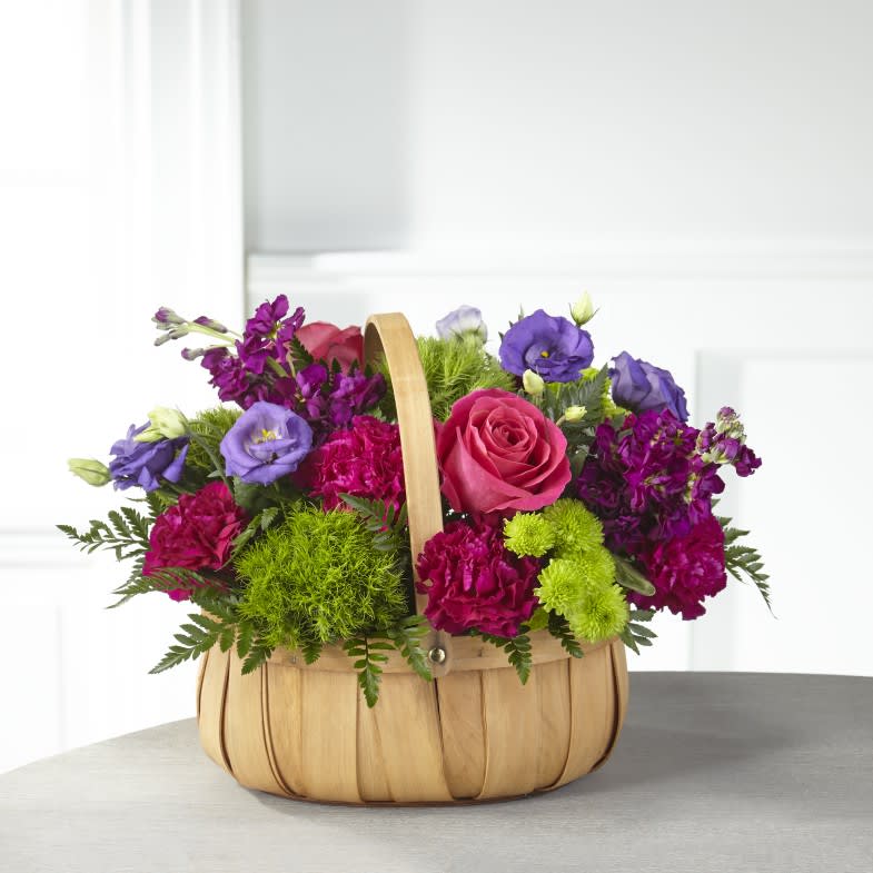 Serene Sanctuary Basket - Share your loving thoughts and heartfelt emotions with an arrangement that captures beauty within each bloom. Bold roses, stock, lisianthus and carnations fill our Serene Sanctuary Basket making it perfect for just about any occasion. 
