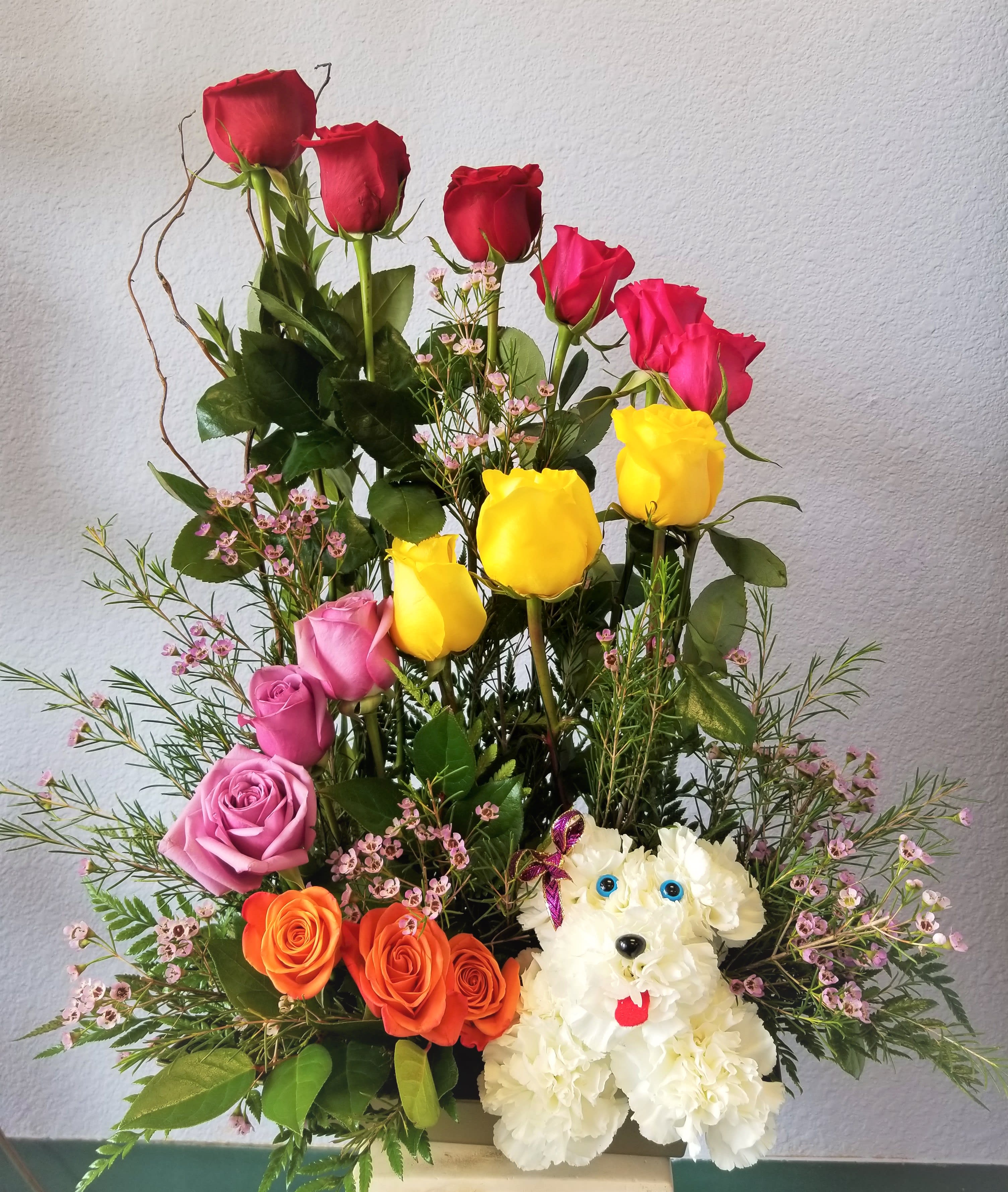 Mixed rose arrangement with a white dog-shaped floral figure