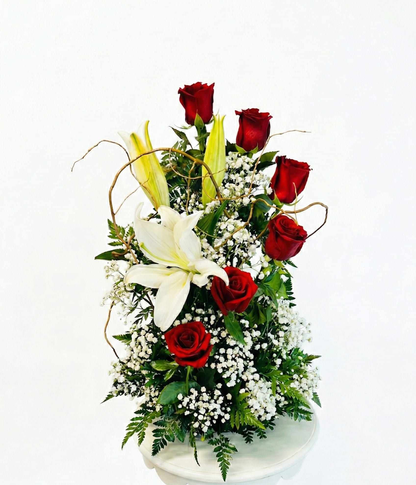 Tall arrangement of red roses and white lilies with baby's breath