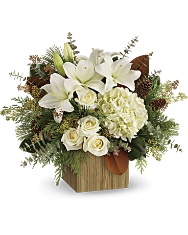 White lilies and roses arranged in a wooden box