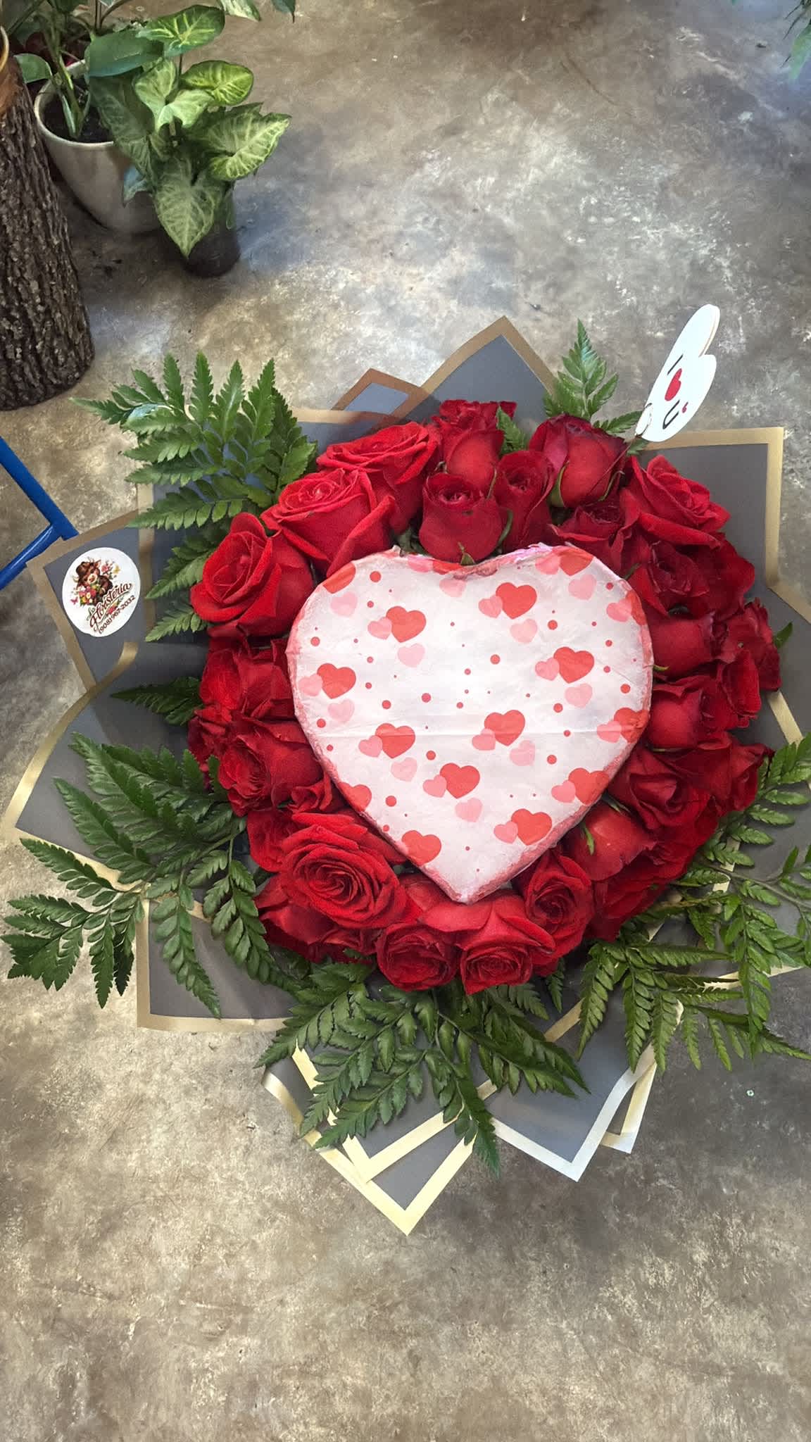 Heart-shaped rose arrangement with a heart decoration in the center