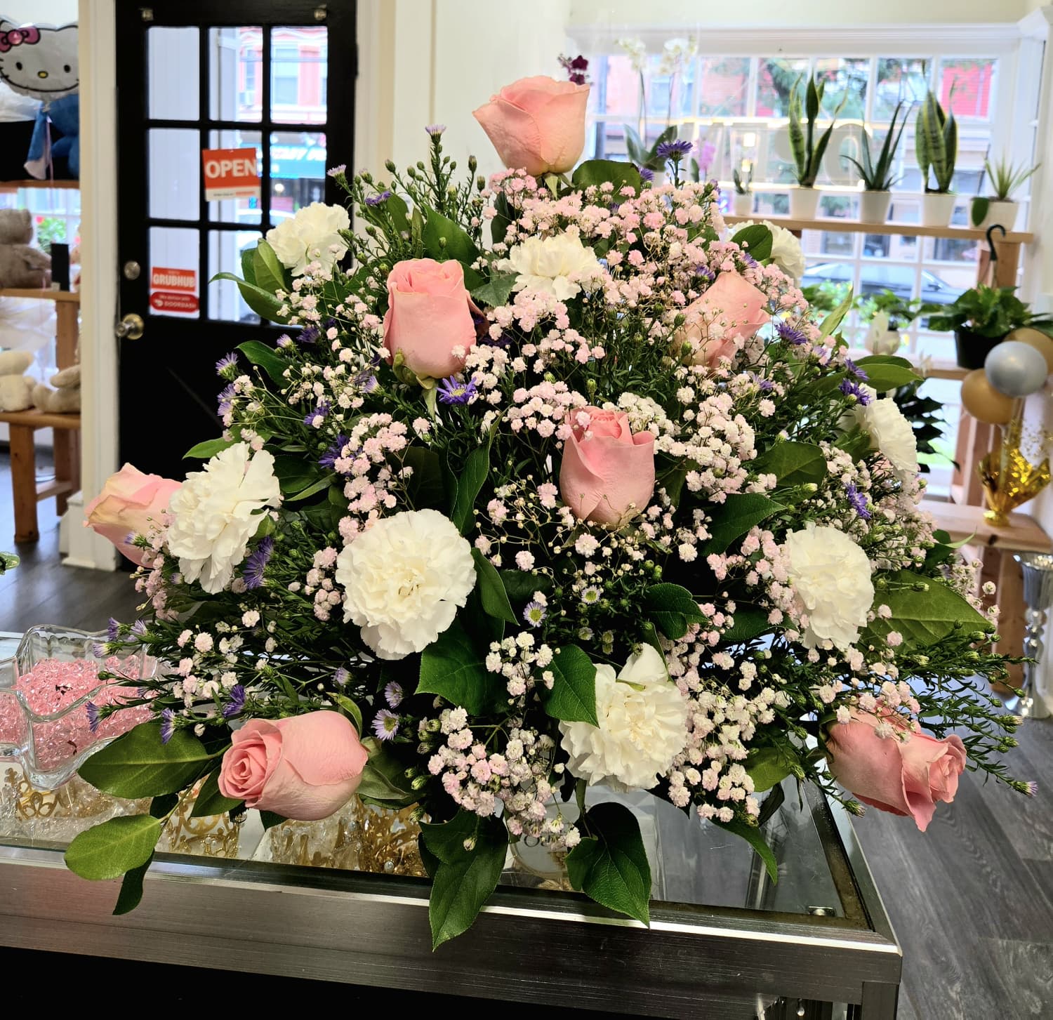 Large bouquet of pink roses and white carnations with baby's breath