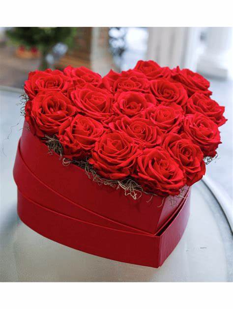 Heart-shaped red box filled with tightly packed red roses