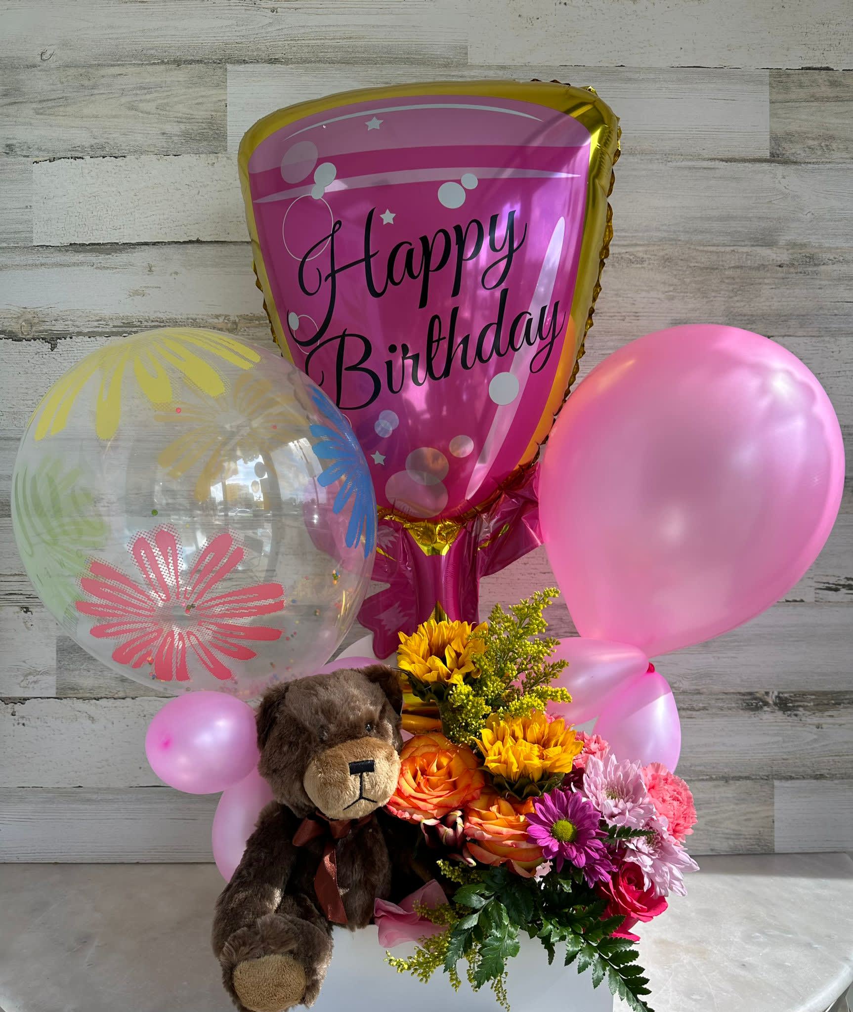 Birthday balloon bouquet with flowers and a teddy bear
