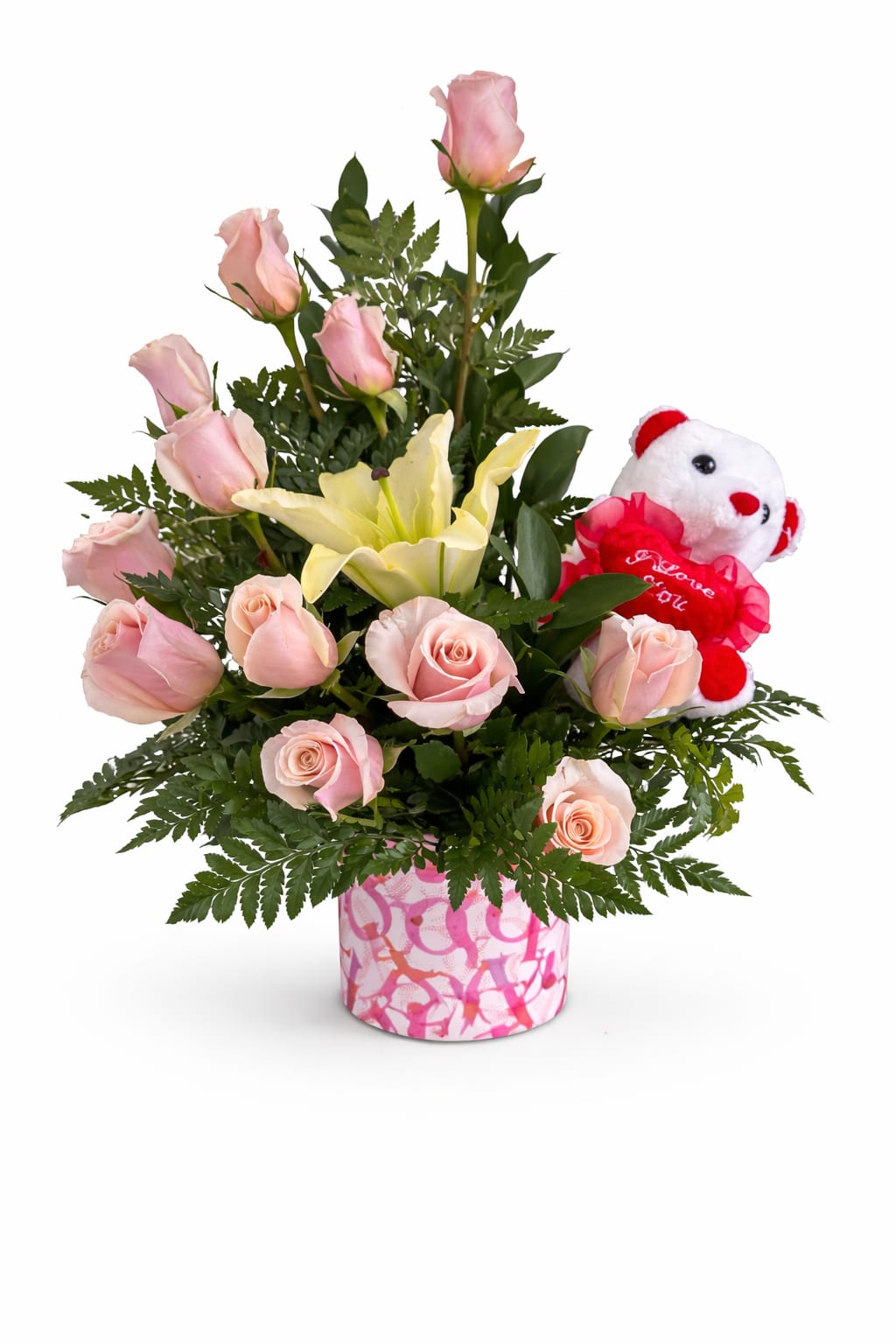 Pink roses and a yellow lily in a pink patterned vase with a teddy bear