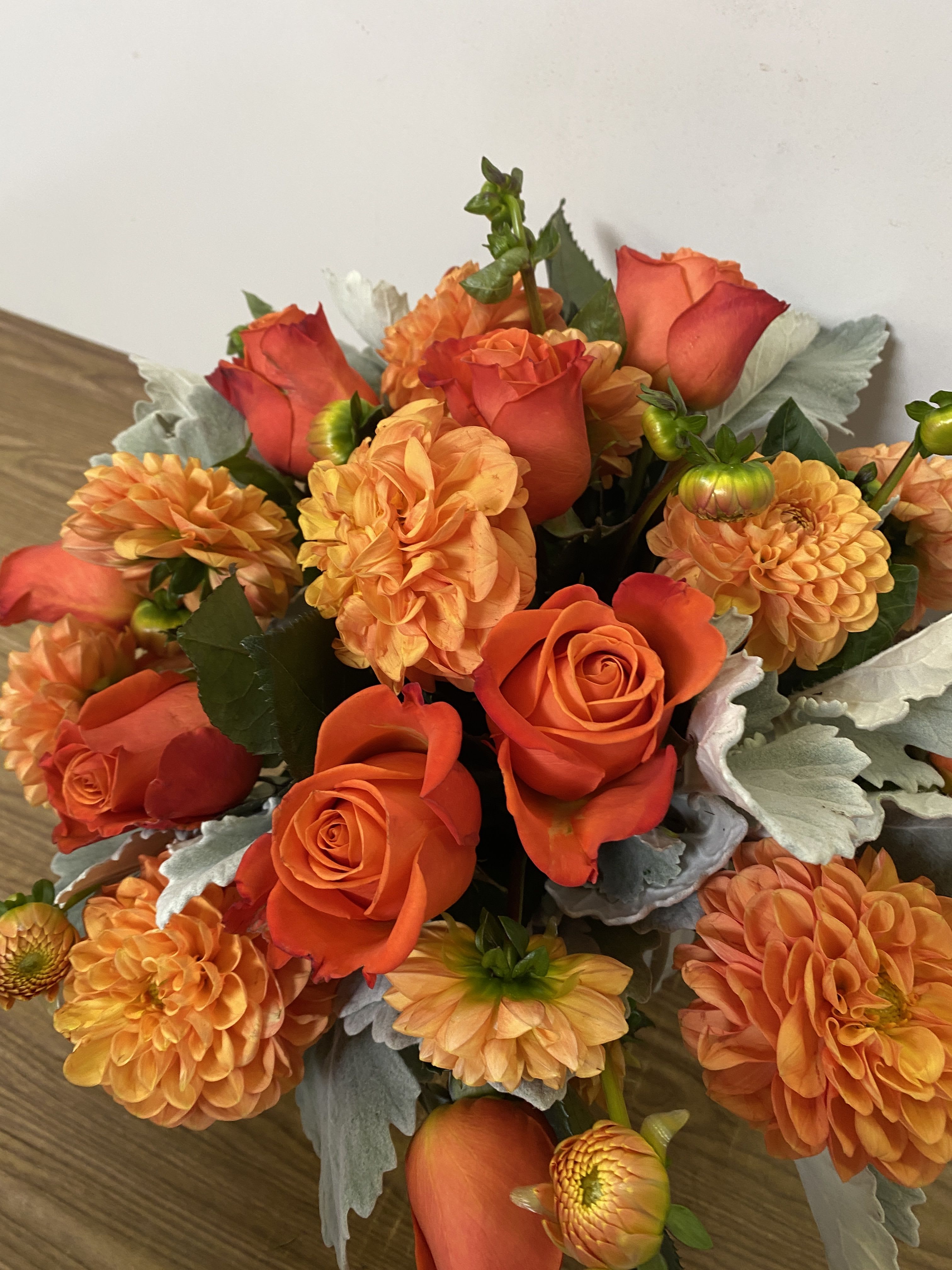 Because I sad so - In a glass vase combinations of orange dollar and orange roses