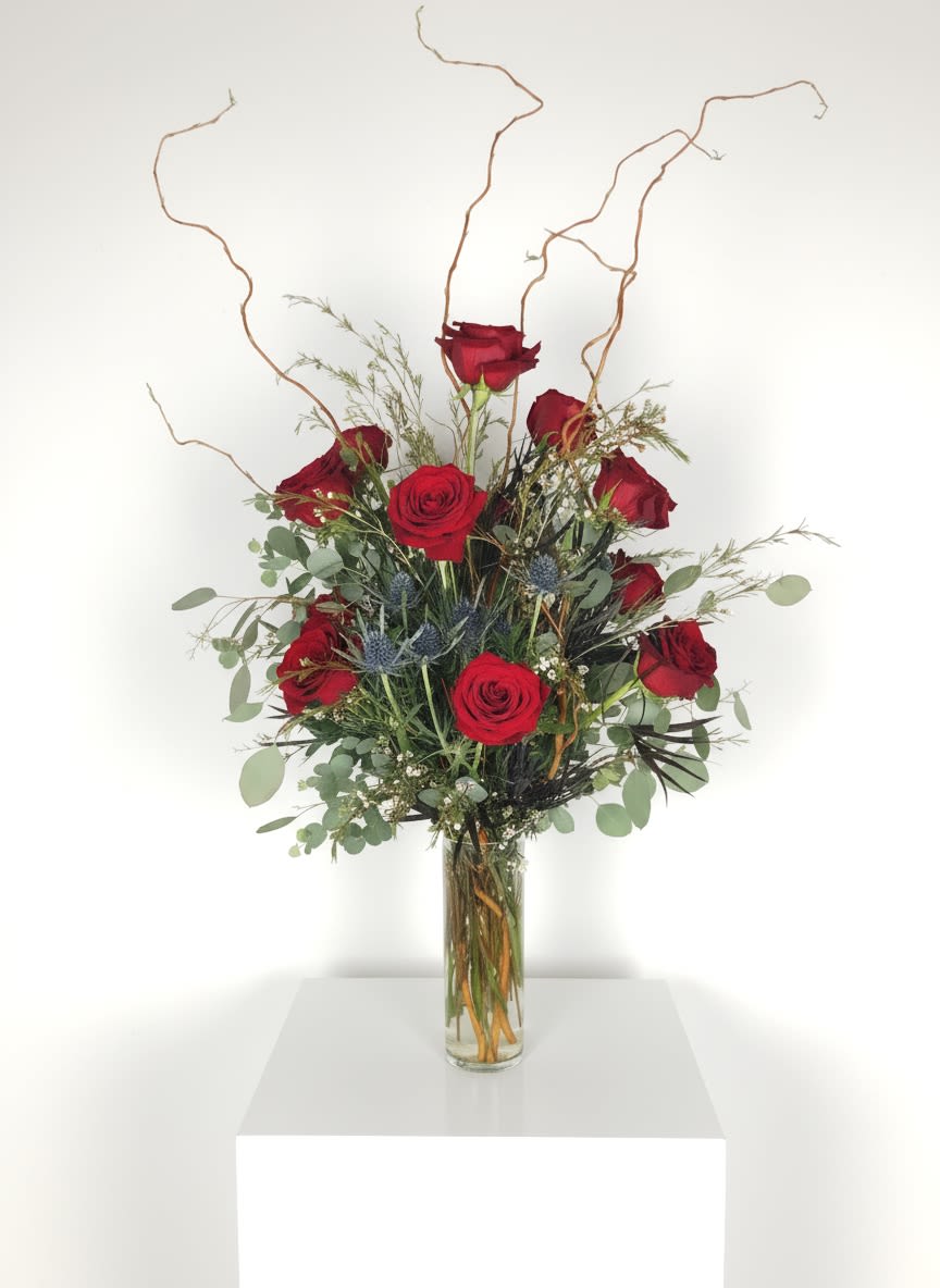 Red Rose Arrangement  - Our rose arrangements are designed to fit the moment, whether you’re sending a romantic gesture, celebrating a milestone, showing appreciation, or simply letting someone know you’re thinking of them.  Choose a classic dozen for a timeless statement, two dozen for a little more impact, or three dozen when you want to make a bold impression. Each arrangement is finished with greens and filler, allowing the roses to take center stage.  Whatever the occasion, roses have a way of making the moment feel special—and creating a gift they’ll remember.  Deliveries are made after 1pm every day. In very cold weather, we prefer not to leave the flowers outside. Please let the recipient know that they should expect delivery.  To give or get flowers weekly or bi weekly, call us and ask about our subscription service.    