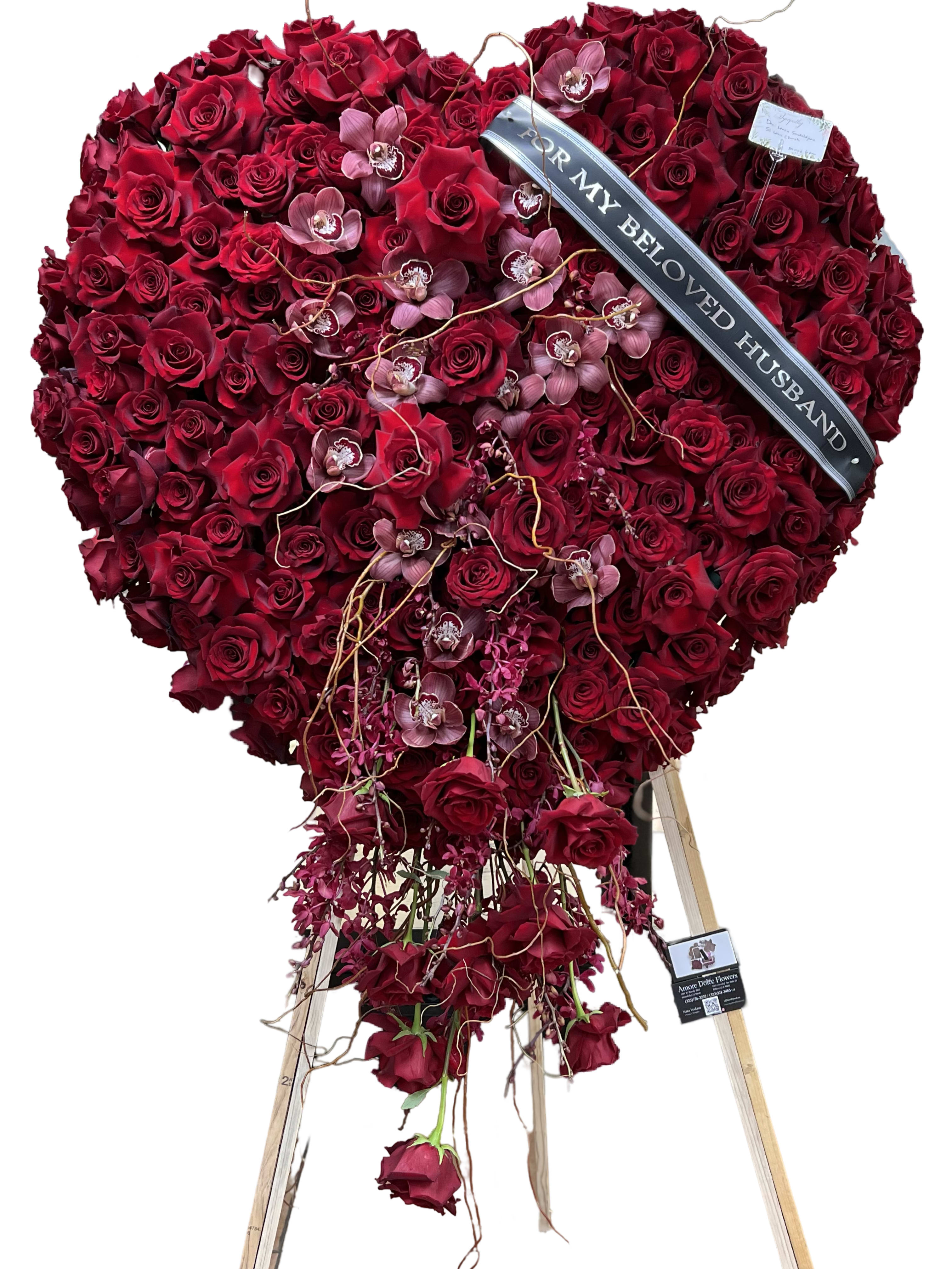 Heart-shaped red rose standing spray with a memorial ribbon