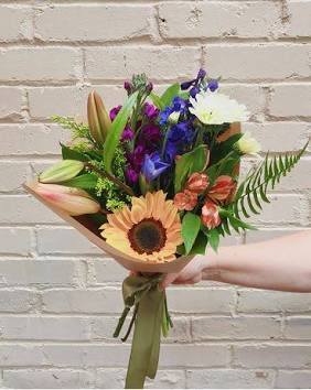 Mixed bouquet with a sunflower, lilies, and purple flowers