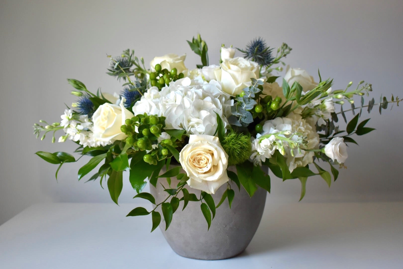 The Touch of Grace Signature - Each arrangement is custom designed, using seasonal, best-of-day blooms. The image shown represents its size, style and temperament, however certain flowers may be substituted to achieve the best quality and longevity for your florals.