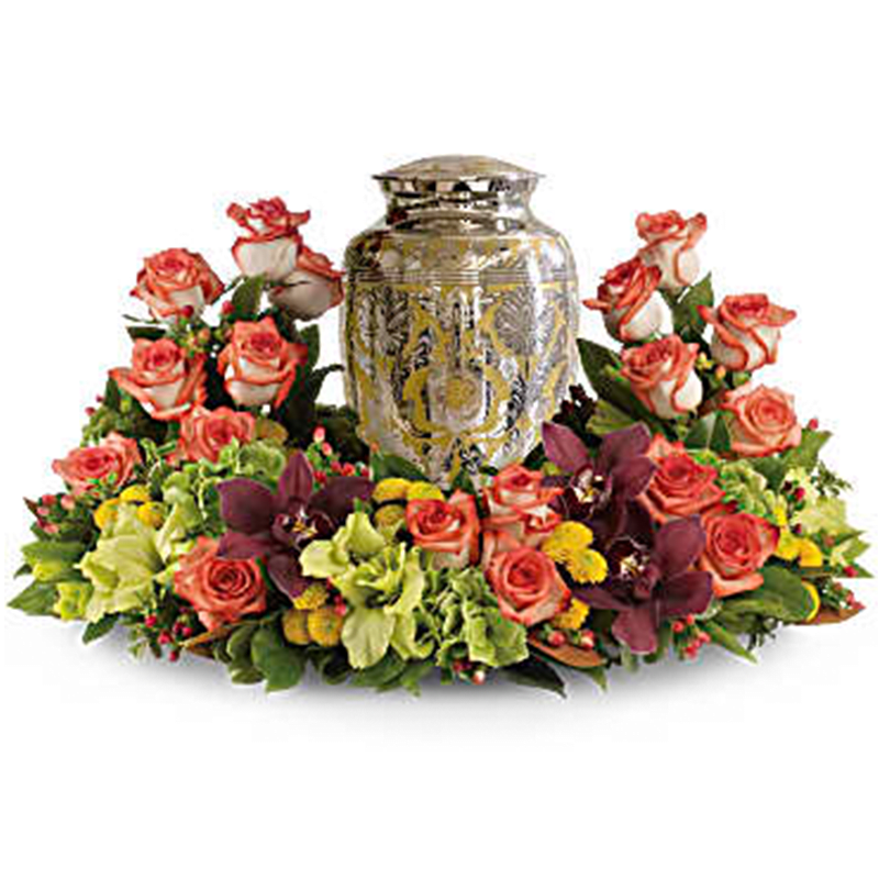 Rose arrangement surrounding an ornate metal urn