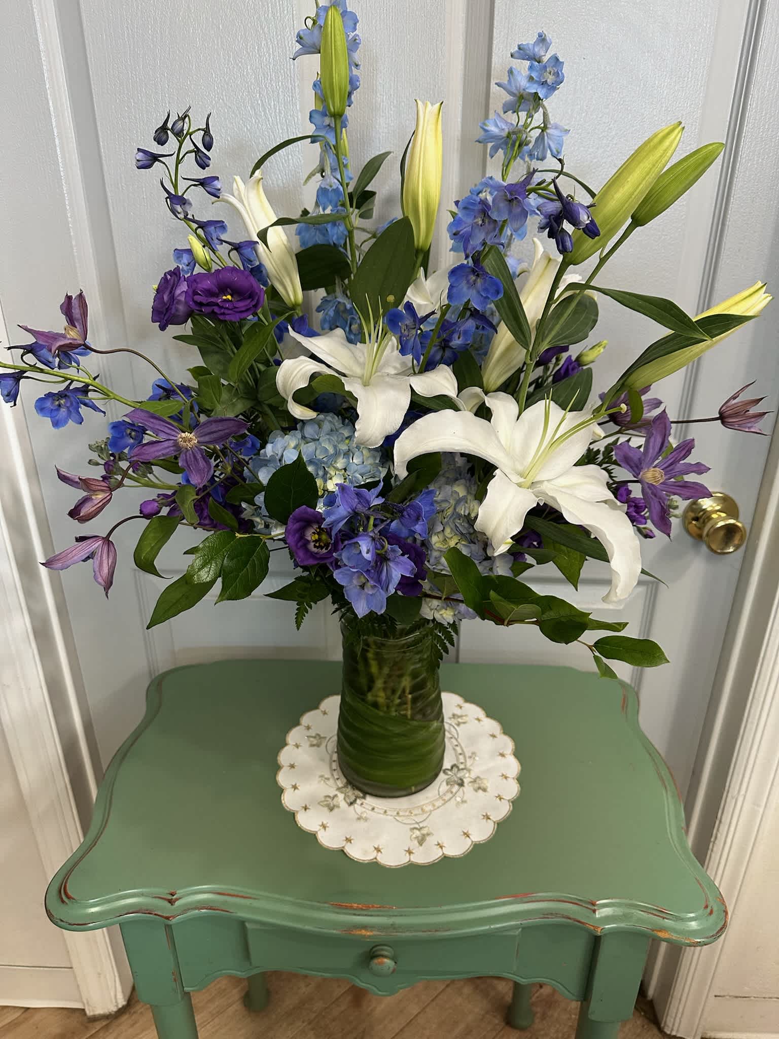 Blue and white floral arrangement in a glass vase