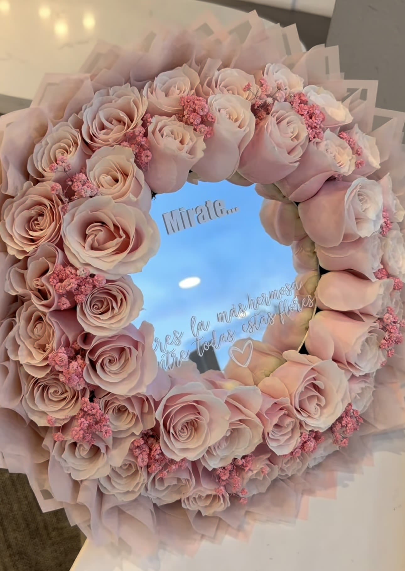 Mirror Rose Bouquet – Personalized Message - A stunning and unique floral design that combines elegance and personalization. This luxury mirror arrangement is surrounded by fresh roses, creating a breathtaking visual effect while reflecting a custom message.  Perfect for birthdays, anniversaries, romantic gifts, or special surprises, this piece is designed to impress and create unforgettable moments.  Each arrangement is handcrafted using fresh premium roses and can be customized with a personalized message on the mirror, making it a truly one-of-a-kind gift.  Due to the natural characteristics of flowers, each design may vary slightly while maintaining the same overall style and quality.