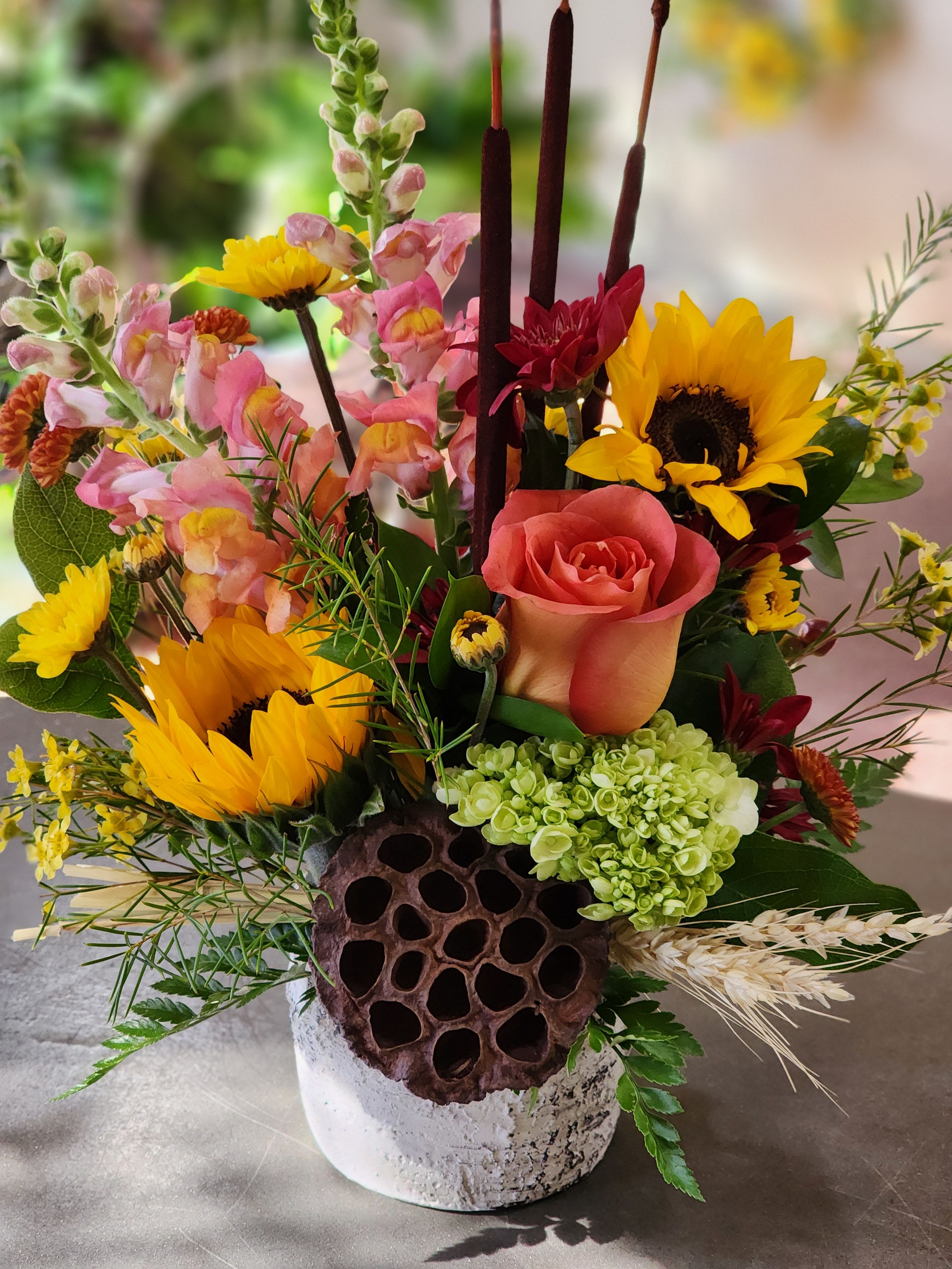 Reeds of hope - This beautiful rustic arrangement,  a sure sign of the fall season. Bright bold sunflowers accented with seasonal colored flowers and dried accents complete this bouquet guaranteed to please for any occasion. 