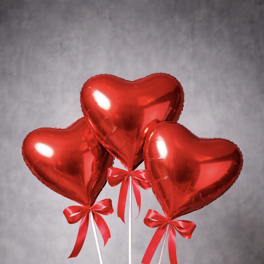 Triple Love - A set of three red heart-shaped balloons on sticks, finished with matching bows. Perfect for adding a sweet touch to any celebration or pairing with a floral arrangement.