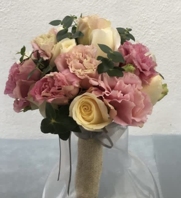 Rustic Bridal bouquet by The House of Flowers - An original bridal bouquet of white roses and pink carnation hand tied with rustic fabric. The perfect complement for a wedding.     