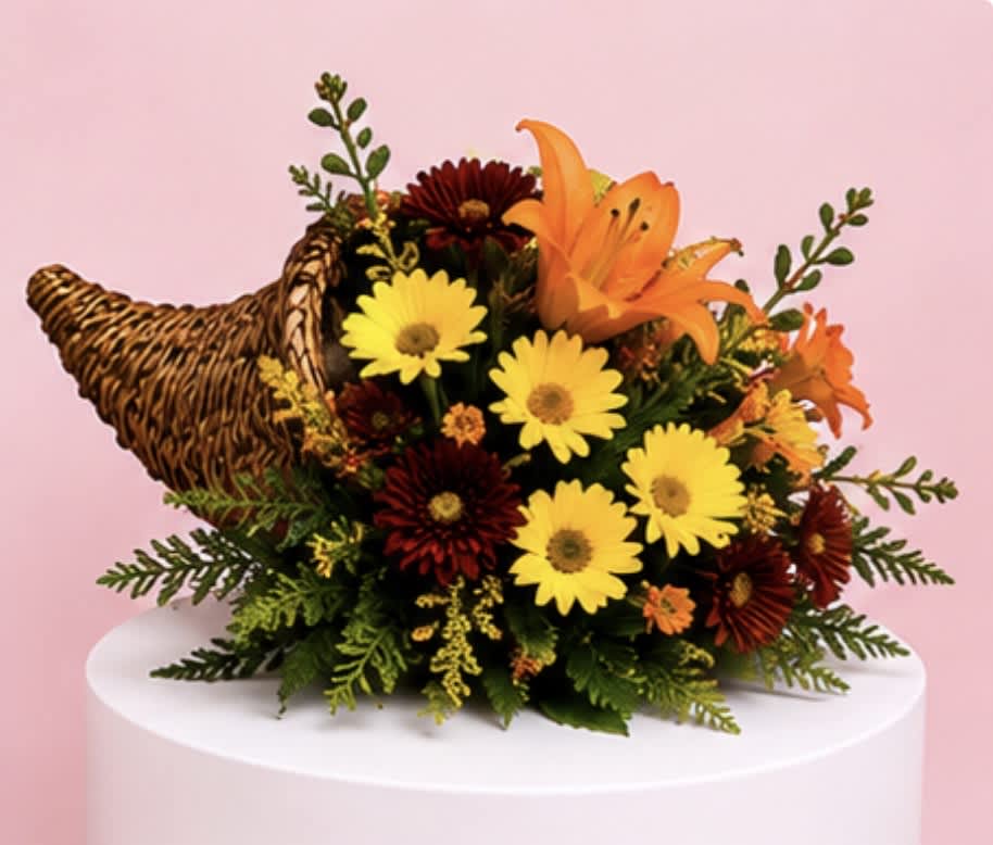 Bouquet of yellow daisies and orange lilies with a woven turkey decoration
