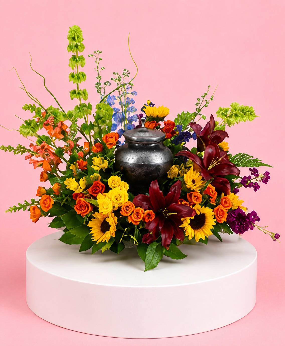 Colorful flower arrangement with a metal urn centerpiece