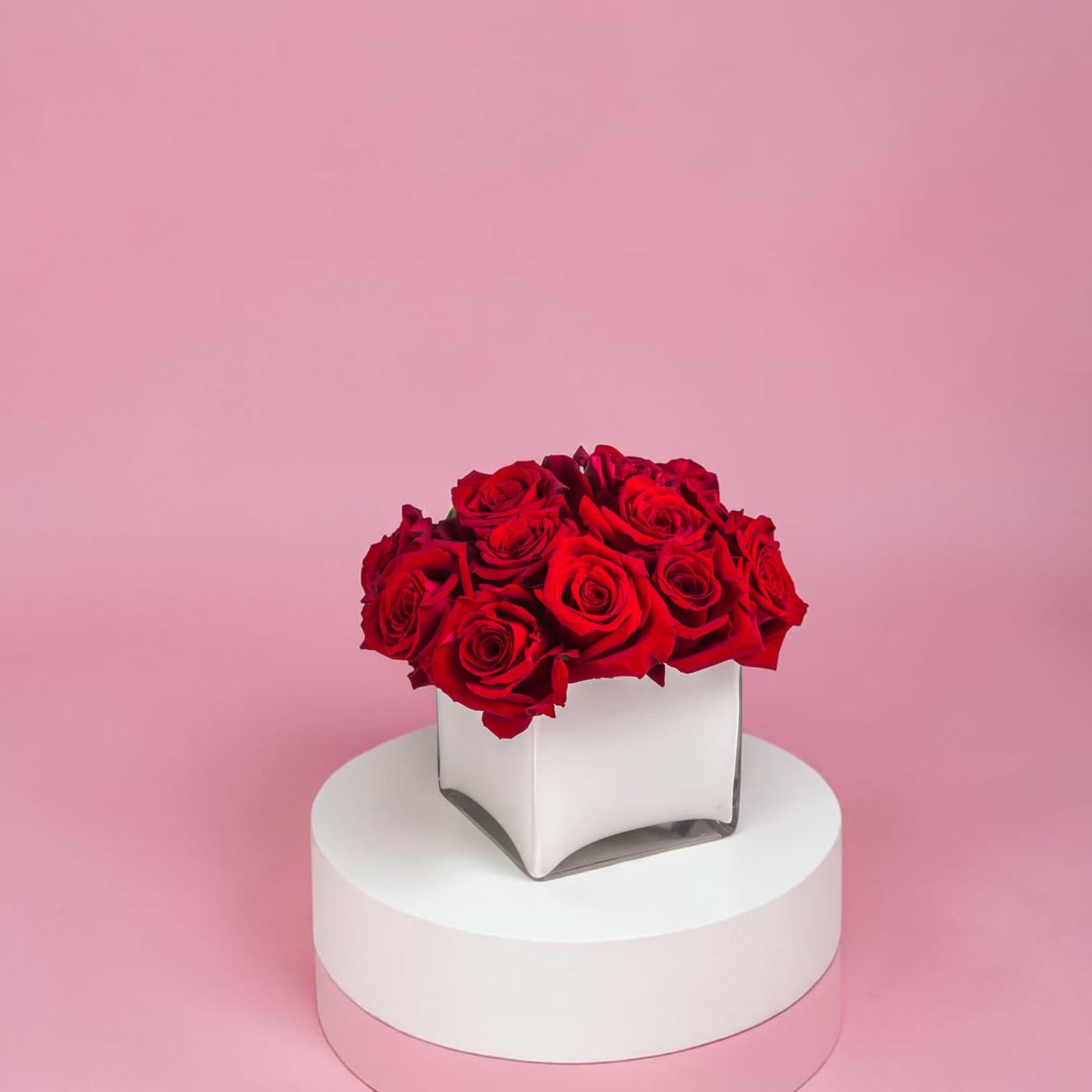 Radiant in Red by BloomNation™ - This bold yet tasteful bouquet is the perfect size for any desk. Radiant in Red by BloomNation™ makes a great gift for Valentine's Day, a Birthday, or an Anniversary.  Arrangement Details: 12 Red Roses in a White, Cubed Vase APPROXIMATE DIMENSIONS 8" H X 10" L X 8"W
