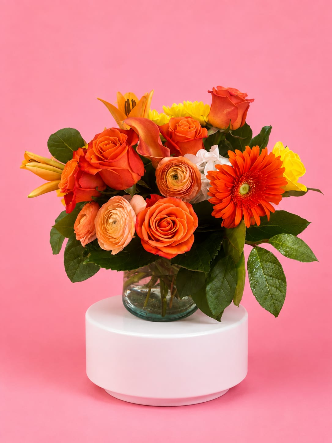 Orange and yellow mixed bouquet in a glass vase