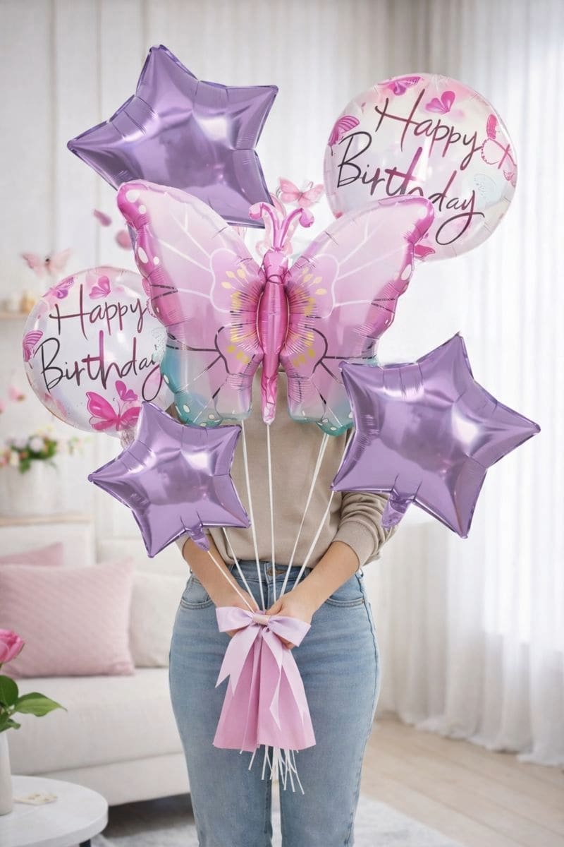 Birthday balloon bouquet with purple stars and a butterfly balloon