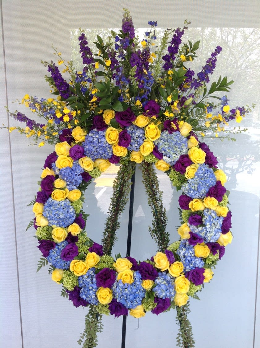 Large floral wreath with yellow and purple roses and blue hydrangeas