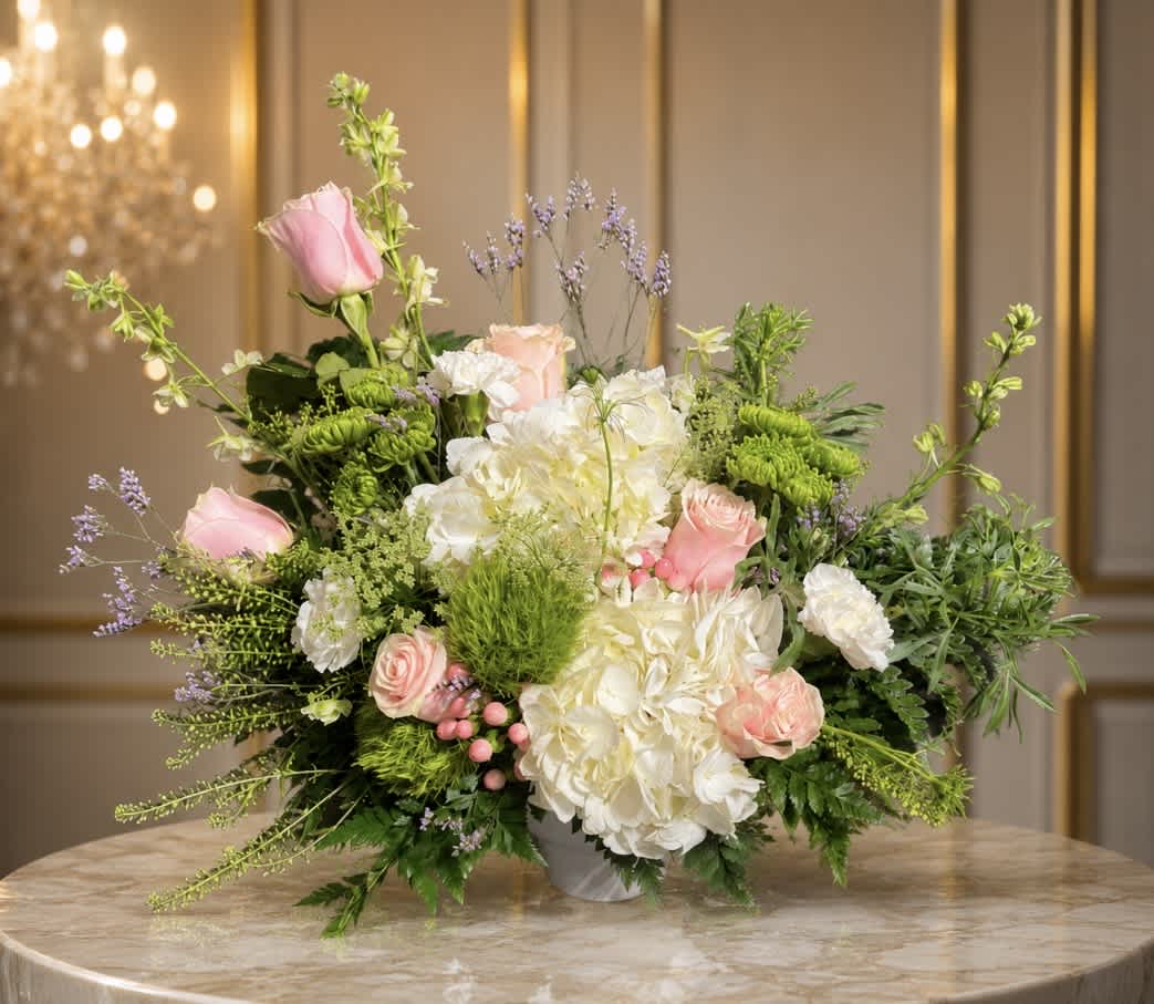 Pink roses and white hydrangeas in a low vase arrangement