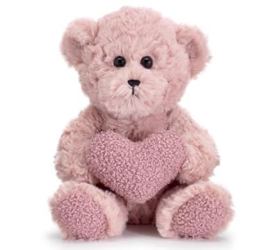 Pink teddy bear holding a heart