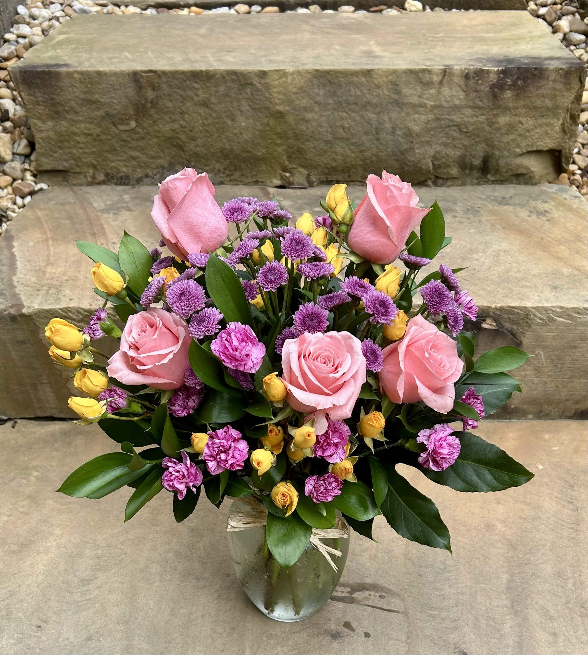 Garden Party - A cheerful mix of pink roses, sunny yellow buds, and playful purple blooms—full of color and joy.