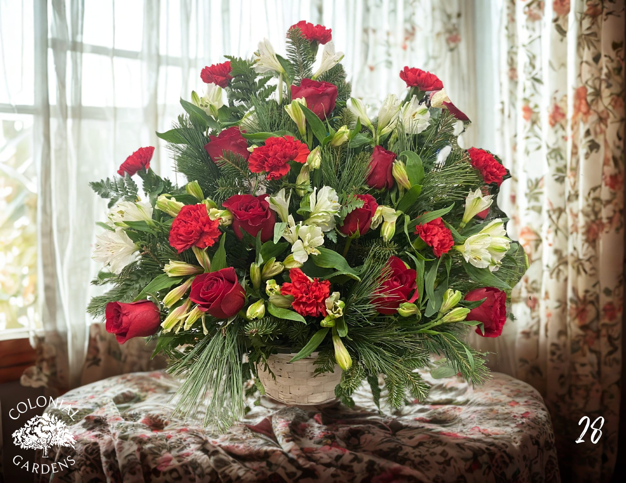 Red roses and white lilies in a basket arrangement