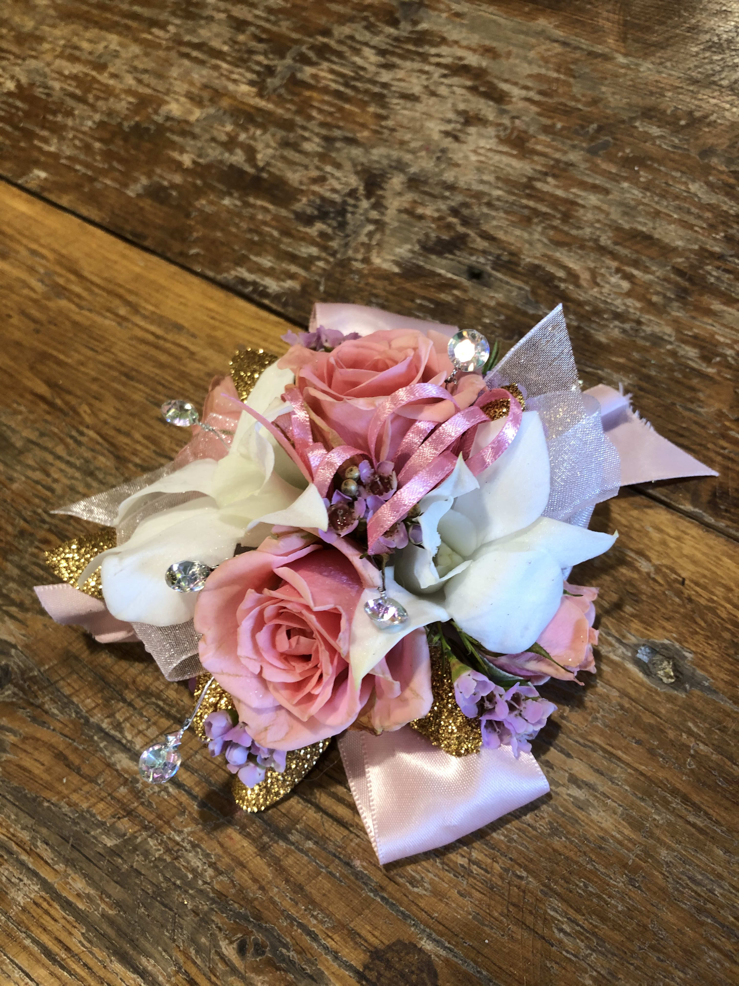 Pink and white rose corsage with ribbon and rhinestone accents