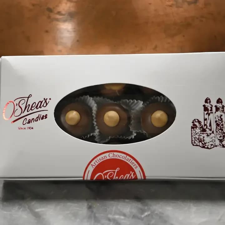 Box of assorted chocolates with a window showing round candies