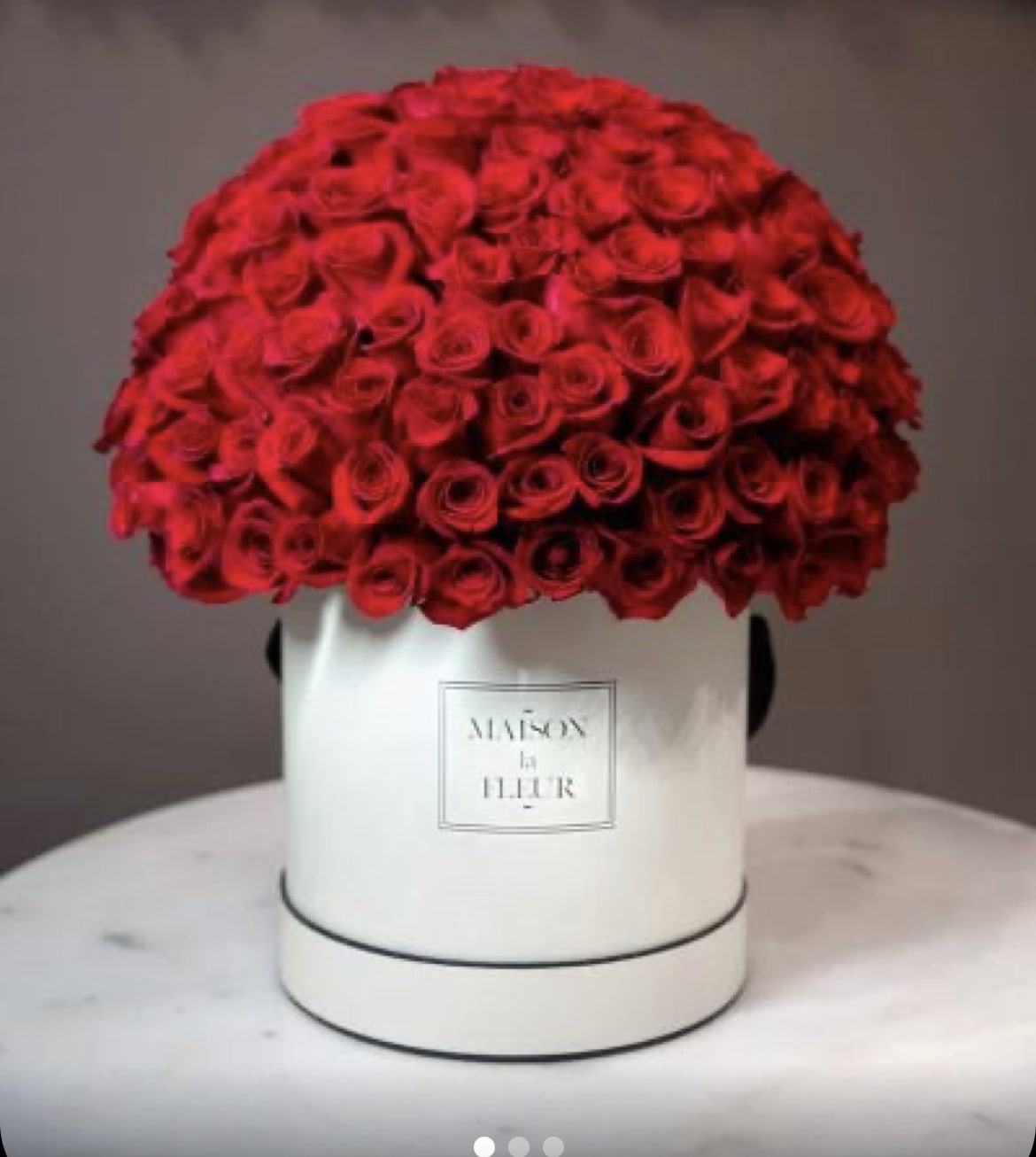 Large dome of red roses in a white hat box