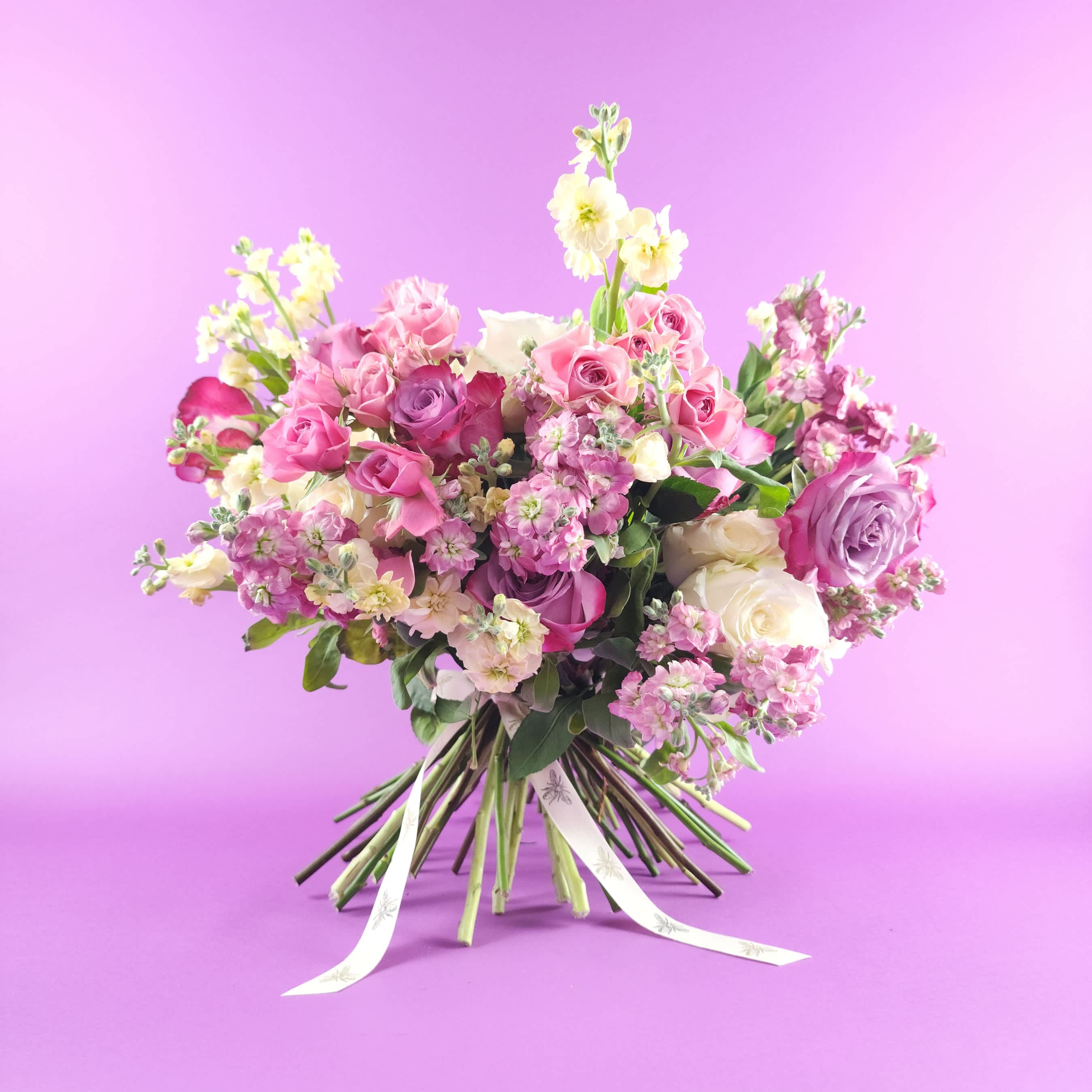 Pink and white rose bouquet with ribbon ties