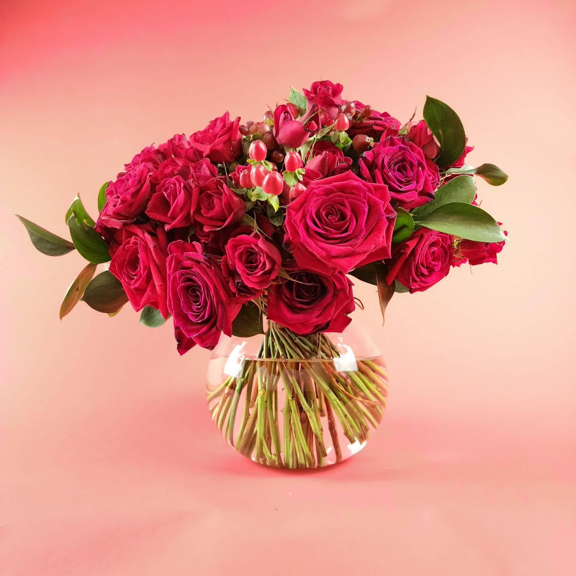 Bouquet of deep pink roses in a clear glass vase