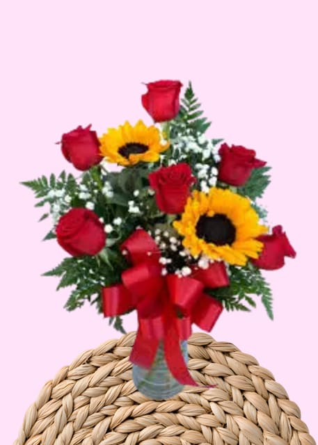 Roses and Sunflowers  - Red Rose &amp; Sunflower Vase Arrangement – A Stunning Blend of Beauty and Brightness Bring joy, warmth, and elegance into any space with this handcrafted floral arrangement featuring vibrant red roses, golden sunflowers, and a lush mix of fresh greens. Designed in a classic vase, this arrangement perfectly balances romance and sunshine, making it a beautiful gift for birthdays, anniversaries, celebrations, or simply brightening someone’s day. Features: •	Fresh, premium red roses •	Bright, cheerful sunflowers •	Lush seasonal greenery for added fullness •	Arranged in a stylish vase •	Perfect for gifting or home décor This arrangement captures both passion and positivity in one stunning display—an eye-catching centerpiece that leaves a lasting impression. 