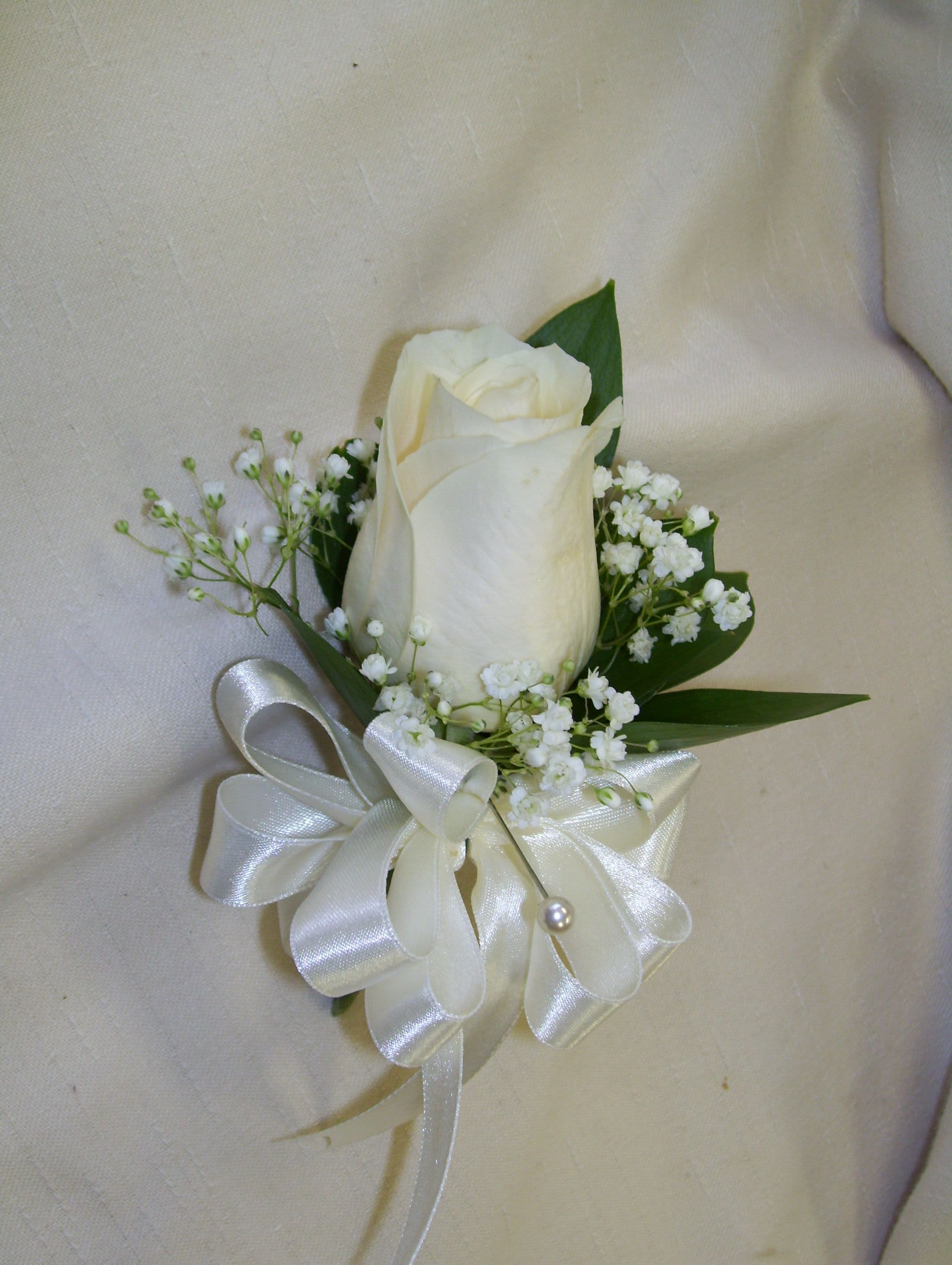 White rose boutonniere with baby's breath and satin ribbon