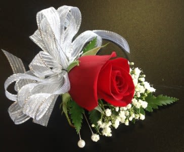Red rose boutonniere with white baby's breath and silver ribbon