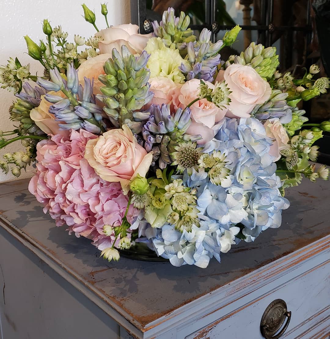 Pastel bouquet of hydrangeas, roses, and small white flowers