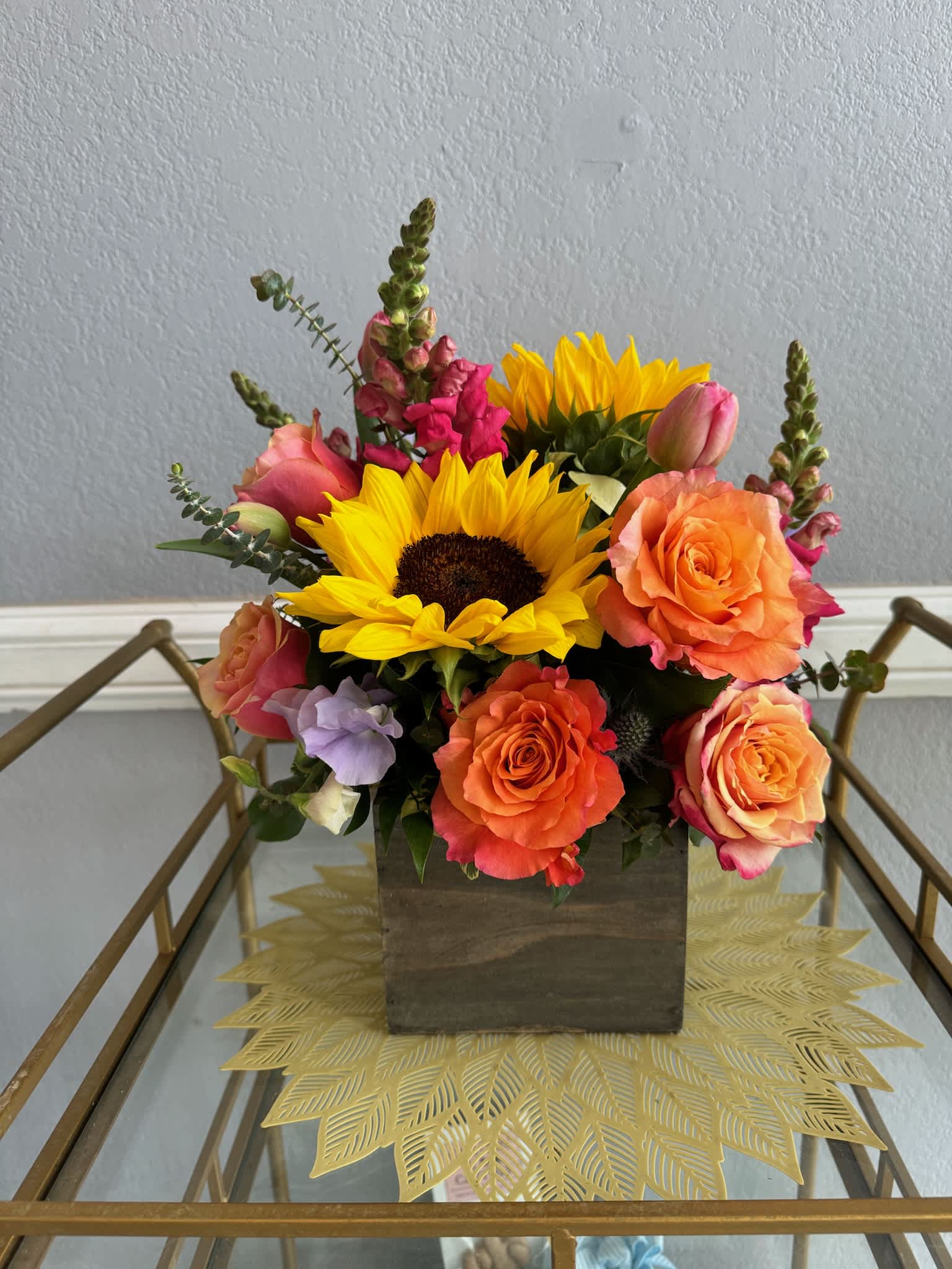 Sunflower and rose arrangement in a wooden box