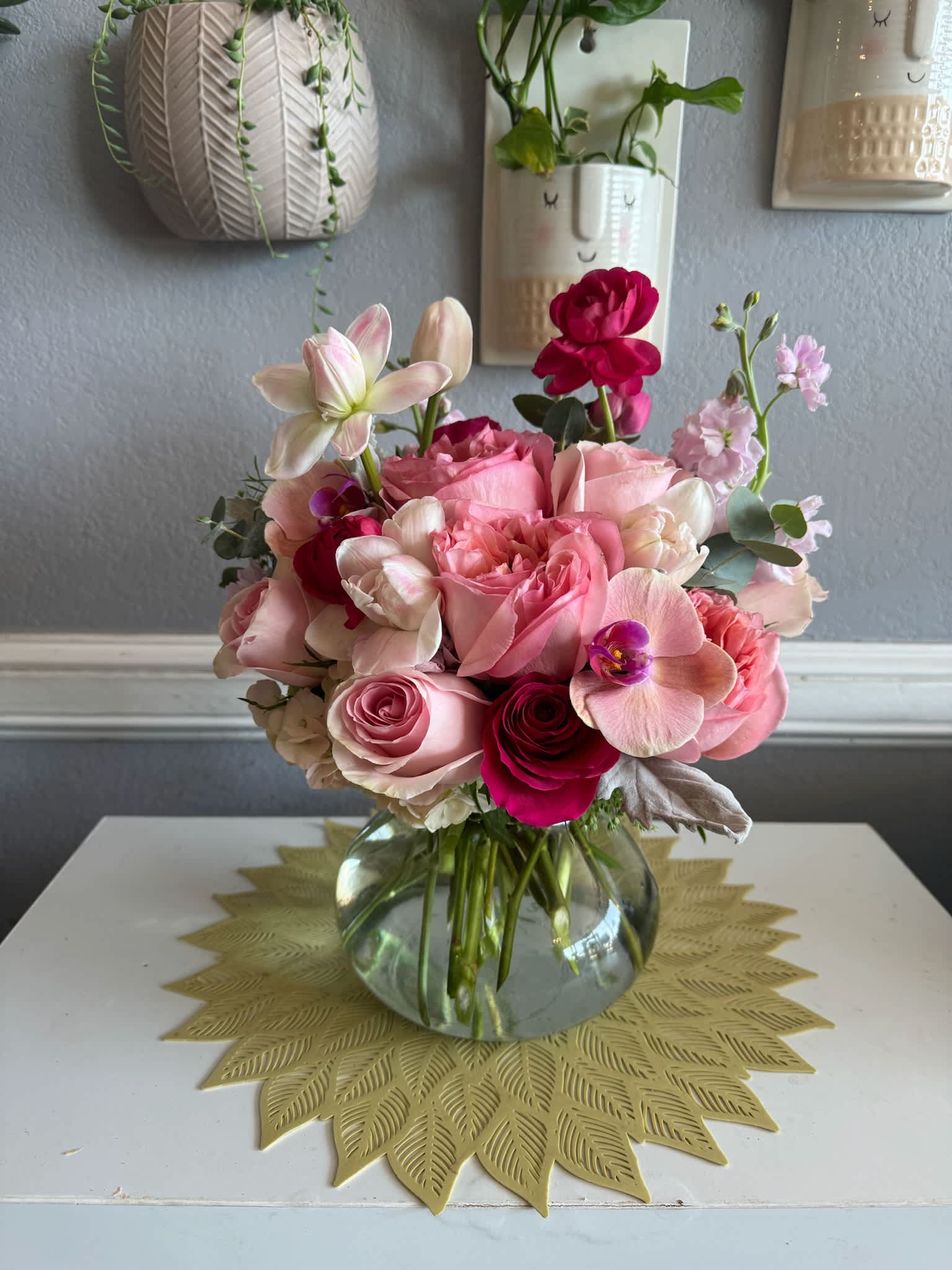 Pink and white rose bouquet in a clear glass vase