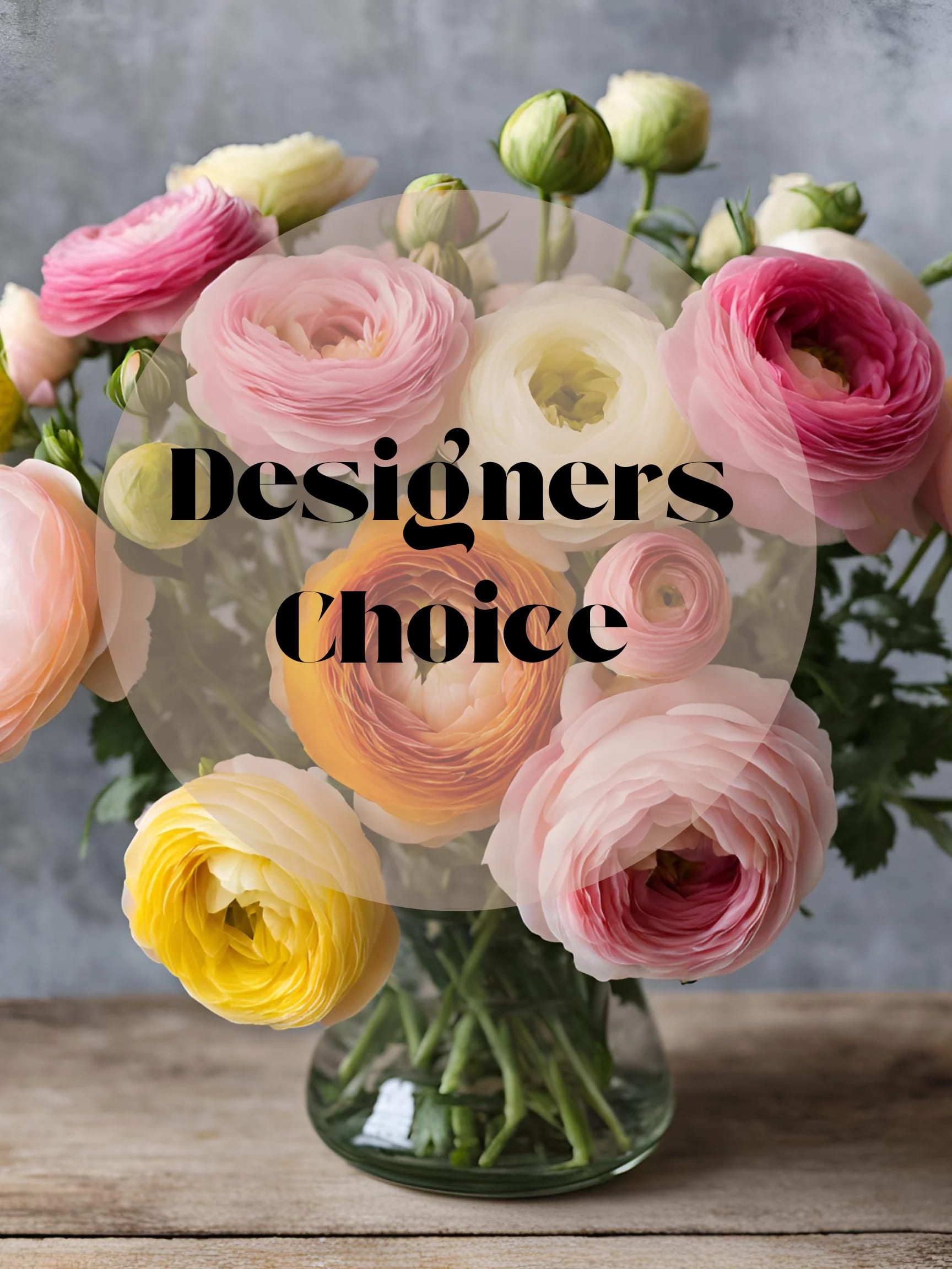 Bouquet of pink, white, and yellow ranunculus in a glass vase