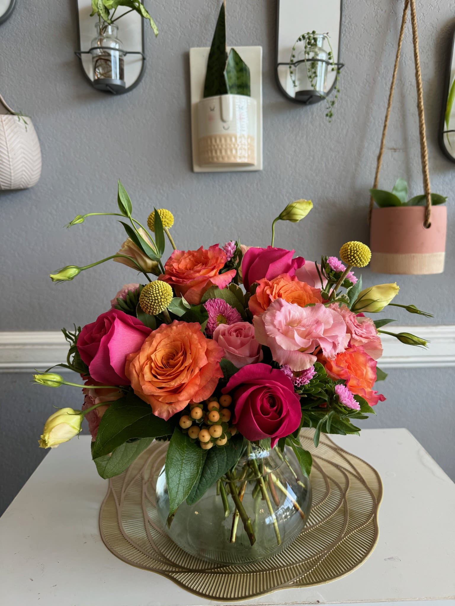 Mixed pink and orange roses in a glass vase