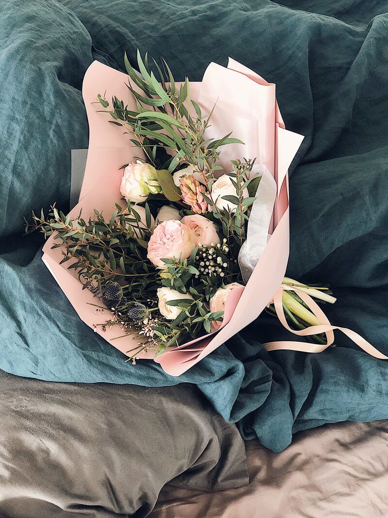 Pink and white bouquet wrapped in blush paper