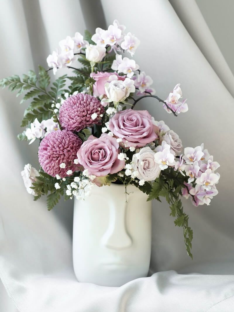 Pink and white floral arrangement in a white vase