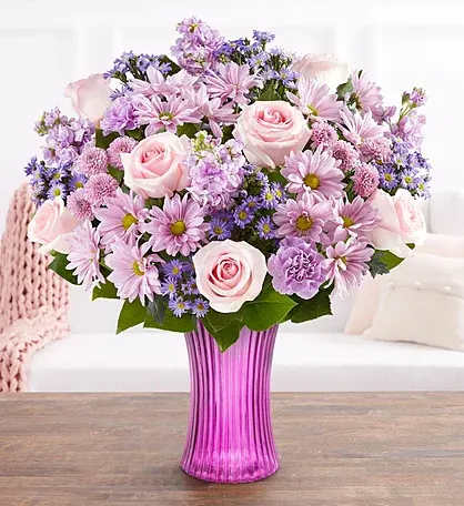 Pink and lavender bouquet in a purple vase